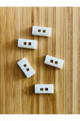 Üstten dikmeli krem bebe düğmesi. 8x16mm. Yarım Çoban Düğme Şekilli.